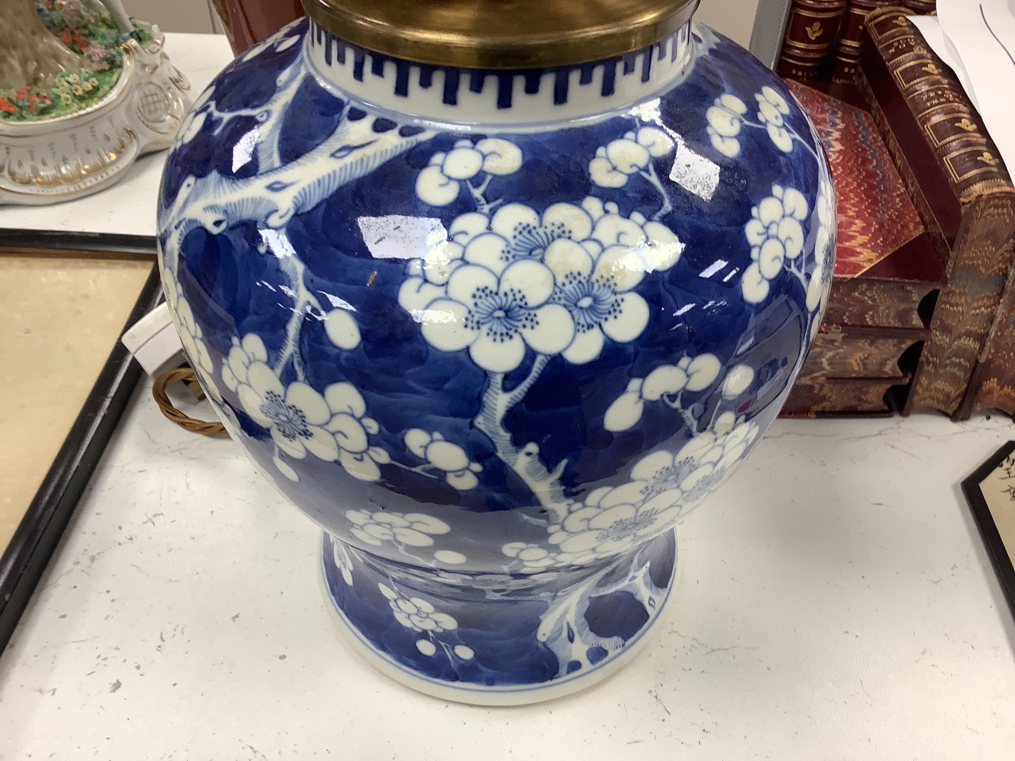 A large Chinese sang de boeuf lamp base and a similar blue and white prunus lamp base, both Qing dynasty, 41 and 21 cm high excluding fittings